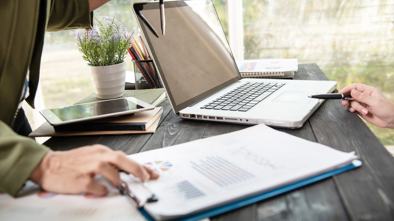 business-woman-hands-using-laptop-computer-placed-messy-office-desktop-scaled.jpg