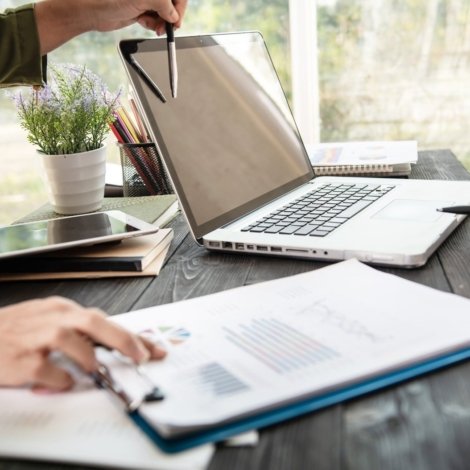 business-woman-hands-using-laptop-computer-placed-messy-office-desktop-scaled.jpg