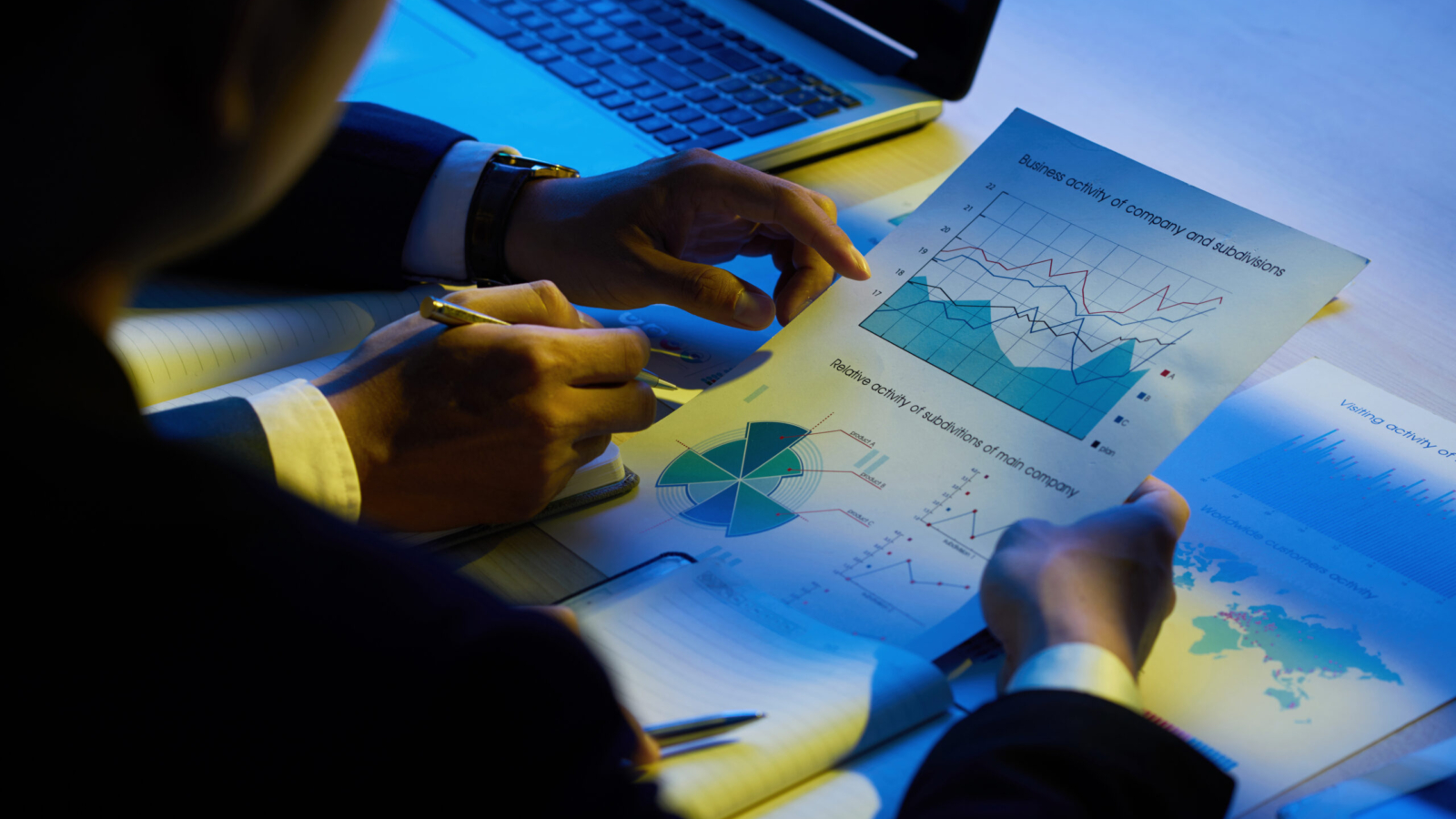 Hands of business executives analyzing company activity