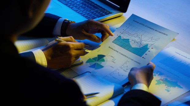 Hands of business executives analyzing company activity