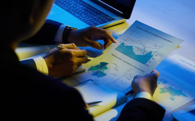Hands of business executives analyzing company activity