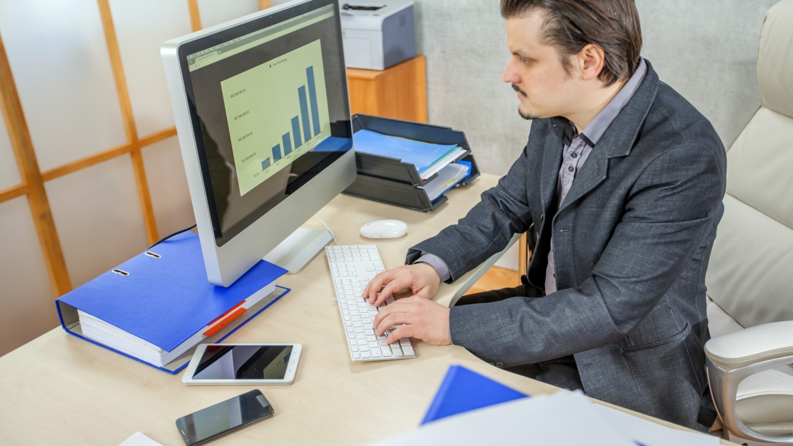 A young businessman working from his office  - the concept of hard work