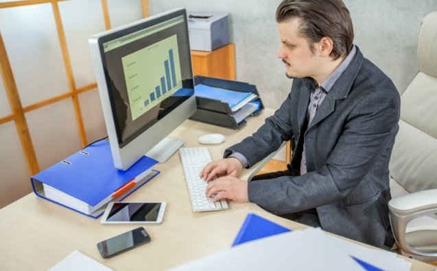 A young businessman working from his office  - the concept of hard work